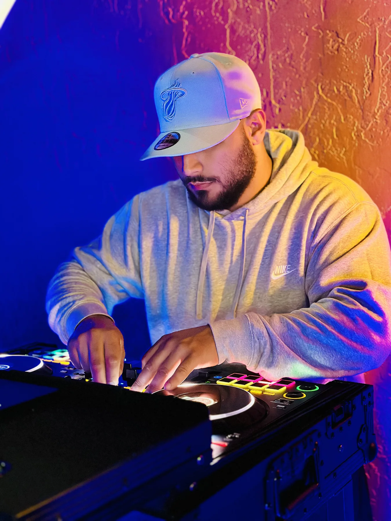 Close-up of Booth Fairy Miami DJ mixing music under event lighting