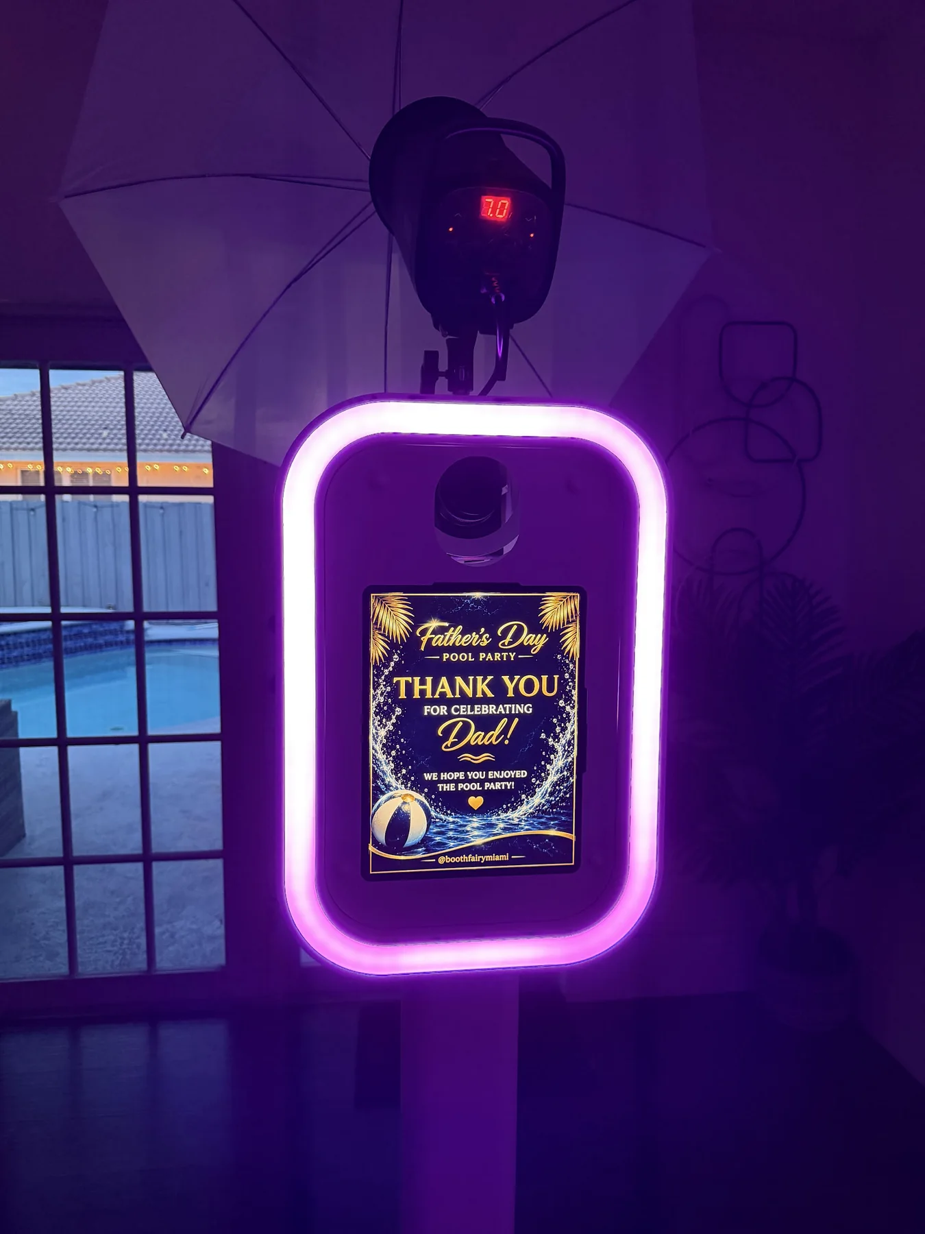 Luxury DSLR photo booth glowing pink at a Miami event